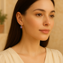 “Sterling silver gold plated amethyst earrings on model with cream dress