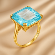 Close-up of large Aquamarine statement ring in gold setting.