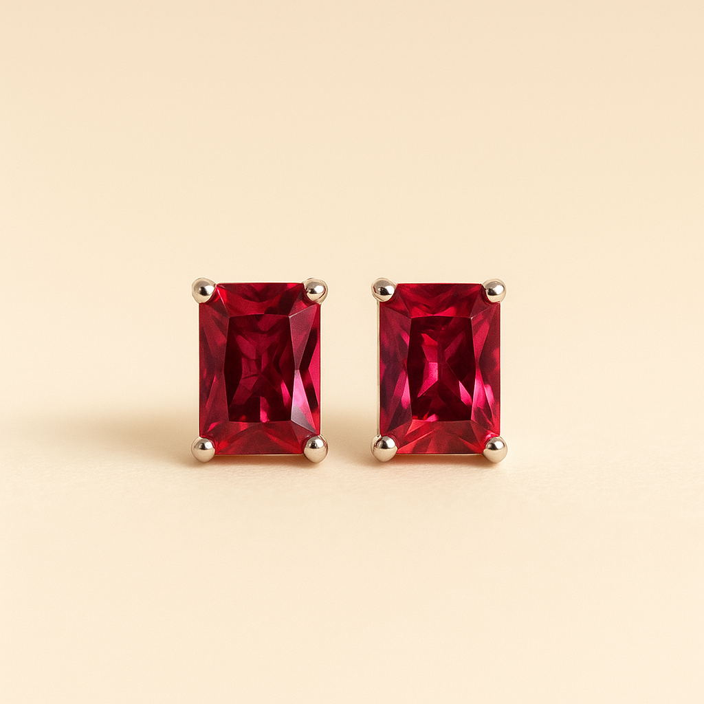 Ruby rose stud earrings on a satin cream box, luxury jewelry styling
