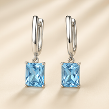 Close-up of aquamarine earrings showing the gemstone clarity