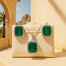 Emerald pendant necklace with 925 silver chain on cream satin backdrop