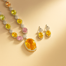 	Elegant morganite and silver necklace worn with classic white blouse.