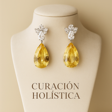 Matching citrine earrings showing stone clarity and craftsmanship”on jewelry bust written Curación Holística at the bottom