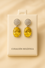 Close-up of Small Citrine and White Quartz Earrings with Satin Cream Background