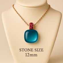 	Blue Topaz and Ruby pendant necklace on beige bust – 12mm stone