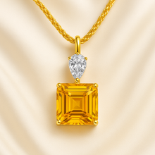 Handmade gold-plated citrine and quartz necklace on cream background