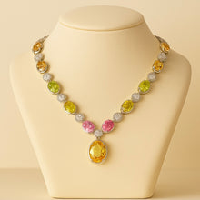 	Luxury necklace featuring citrine, peridot, and rose quartz on jewelry bust.