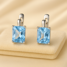 Close-up of boho chic aquamarine earrings with reflective gemstone shine