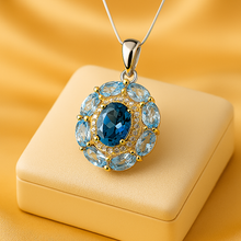 Close-up of sterling silver and gold plated pendant with topaz center