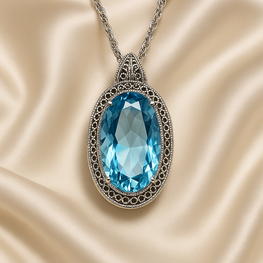 	Large aquamarine oval pendant necklace on cream satin background