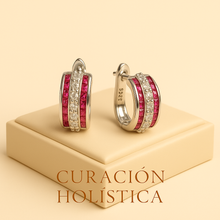 Curación Holística branded ruby and quartz earrings in luxury packaging”