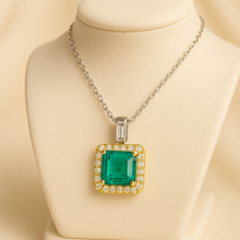 	“Artisan emerald halo necklace symbolizing love, healing, and timeless luxury in sterling silver and gold.”