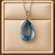 Close-up of handcrafted aquamarine necklace with pear-cut stone