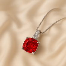 Close-up of gold-plated sterling silver ruby necklace with white quartz accents.”