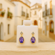“Artisan earrings photographed in soft Mediterranean setting”