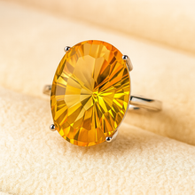 Side angle showing sunburst facets of natural citrine gemstone in a four-prong setting.”