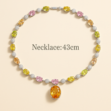 Close-up of healing gemstones: rose quartz, peridot, and citrine in sterling setting.