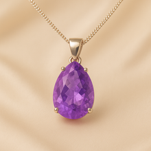 Close-up of purple amethyst stones in matching pendant and earrings