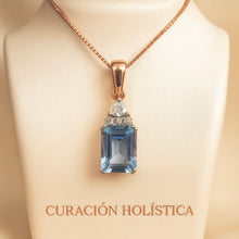 Tiny handmade aquamarine pendant displayed on cream mannequin