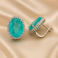 Oval tourmaline and white quartz earrings, side angle on velvet