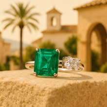 Elegant open-end silver ring with green emerald on satin background