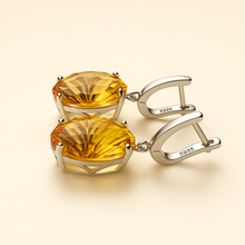 Sterling silver earrings featuring vibrant oval-cut citrines