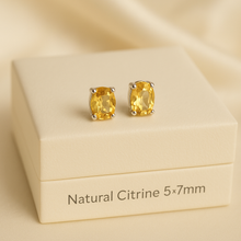 Close-up of 5x7mm citrine earrings with silver prong setting
