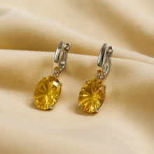Sterling silver earrings featuring vibrant oval-cut citrines