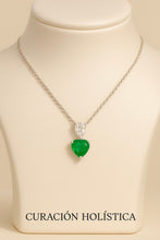 “Elegant emerald heart pendant necklace with a white quartz accent in a sterling silver setting, exclusive design by Curación Holística, photographed in a Mediterranean-inspired backdrop.”