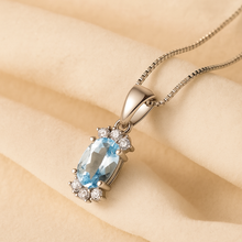	Natural aquamarine pendant necklace in sterling silver on velvet background