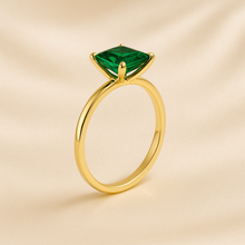 Close-up of lab-grown emerald ring with gold finish