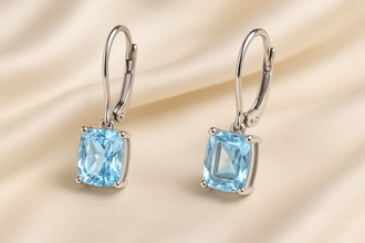 Close-up of cushion-cut aquamarine stone in silver prongs