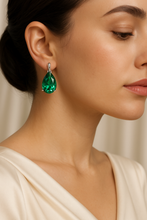 “Close-up of vibrant green Nano-Emerald earrings with polished sterling silver setting, artisan-crafted for Curación Holística.”