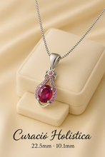 Close-up of handcrafted sterling silver and gold-plated ruby pendant necklace.