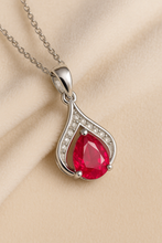 Ruby pendant necklace on a silver chain, exuding romantic Spanish vibes.”