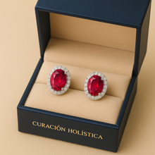“Close-up of oval ruby earrings with shimmering white quartz halo in sterling silver gold plating.”