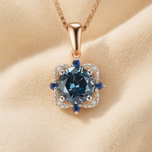 Close-up of London topaz and sapphire necklace on cream background