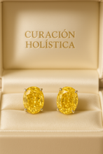 “Handmade statement citrine studs – radiant yellow gemstones on soft satin background.”