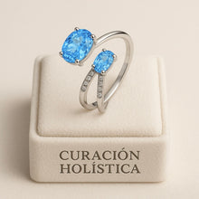 Elegant artisan ring featuring topaz and sterling silver open band design