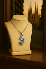 Statement jewelry featuring aquamarine and topaz on soft cream surface