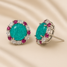 Front view of 1.5 cm round tourmaline surrounded by white quartz and rubies