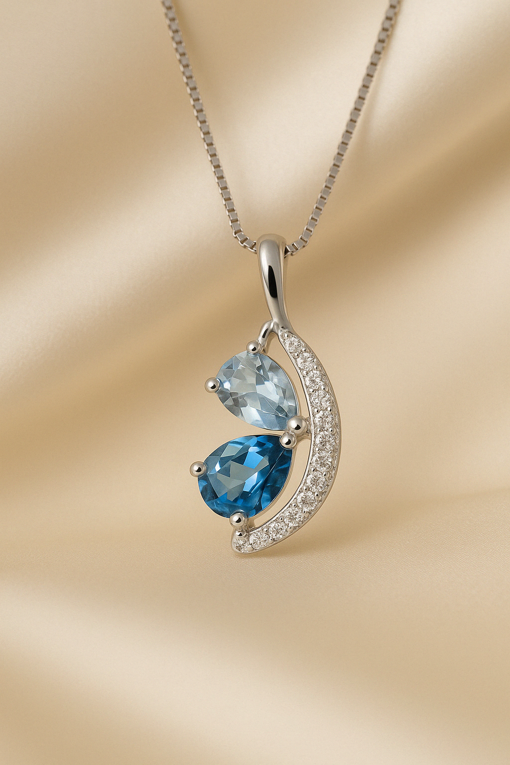 Close-up of pear-cut blue gemstones in gold-plated silver setting