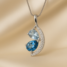 Close-up of pear-cut blue gemstones in gold-plated silver setting