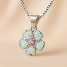 “Imagine a soft sunrise woven into a bloom of precious stones—each opal petal catching the first light of morning, while a tender rose quartz heart hums quietly at its center. With this necklace, you don’t just wear jewelry; you wear a promise of beauty, love, and renewal crafted by hand, and kissed by the spirit of Curación Holística.”