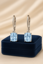 Lifestyle photo of earrings worn on a model