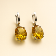 	Artisan-crafted yellow gemstone earrings in solid silver