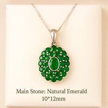 Natural emerald oval pendant glowing in professional jewelry lighting
