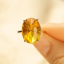 Golden citrine ring styled with boho-chic bracelets for a stacked jewelry look.”