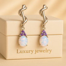 “Artisan-crafted opal and amethyst earrings offering spiritual energy and timeless beauty.”