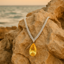 	“Side view of handmade Italian citrine necklace on rusty mountain in Spain